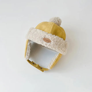 A kids' winter hat made of velvet with a fur lining, primarily in yellow and white colors, with a plush design.